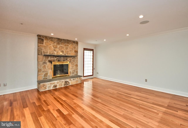 unfurnished living room featuring a fireplace, light hardwood / wood-style floors, and ornamental molding