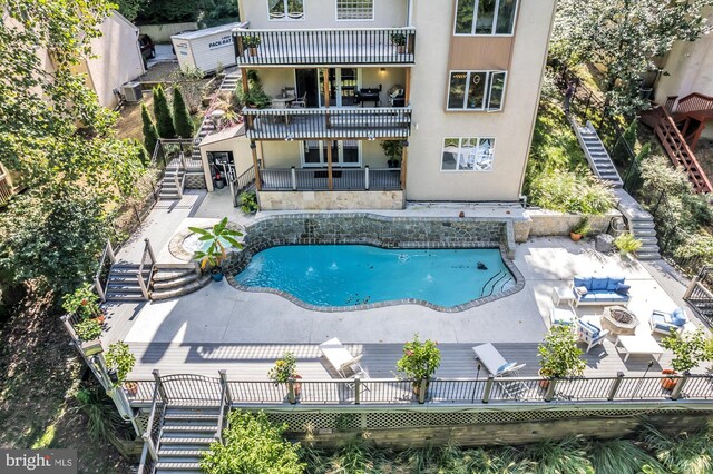 view of pool with a fire pit and a patio area