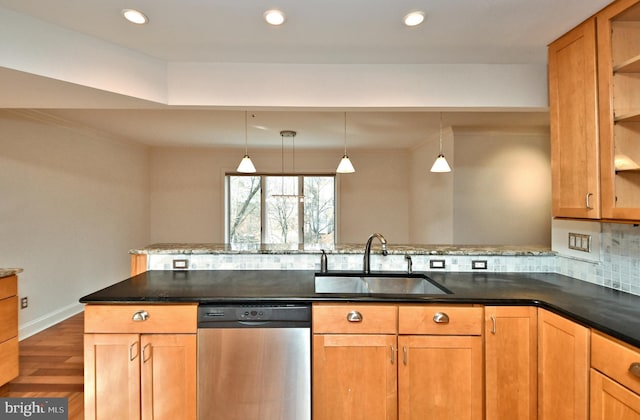 kitchen with dishwasher, dark wood-type flooring, sink, tasteful backsplash, and kitchen peninsula