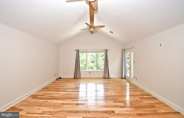 empty room featuring light wood-type flooring, lofted ceiling with beams, and ceiling fan