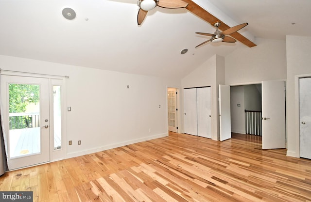 unfurnished bedroom with access to exterior, lofted ceiling with beams, light hardwood / wood-style flooring, and ceiling fan