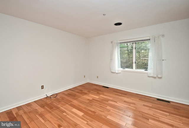 empty room with light hardwood / wood-style floors