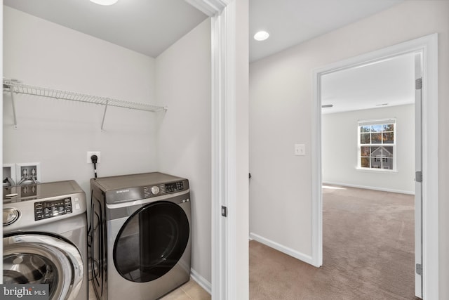 washroom featuring washing machine and clothes dryer and light carpet