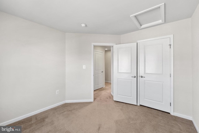 unfurnished bedroom featuring light colored carpet