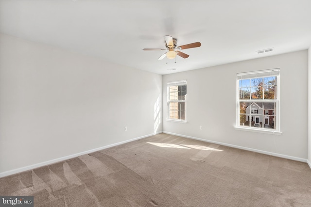 carpeted empty room featuring ceiling fan