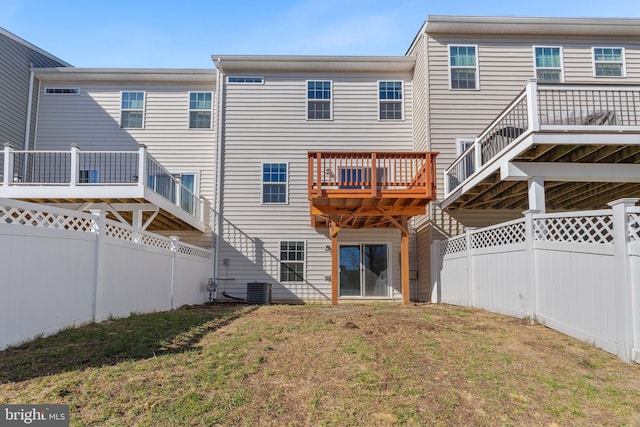 back of house featuring a deck, central air condition unit, and a yard