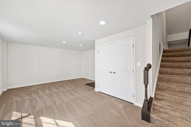 basement featuring light colored carpet