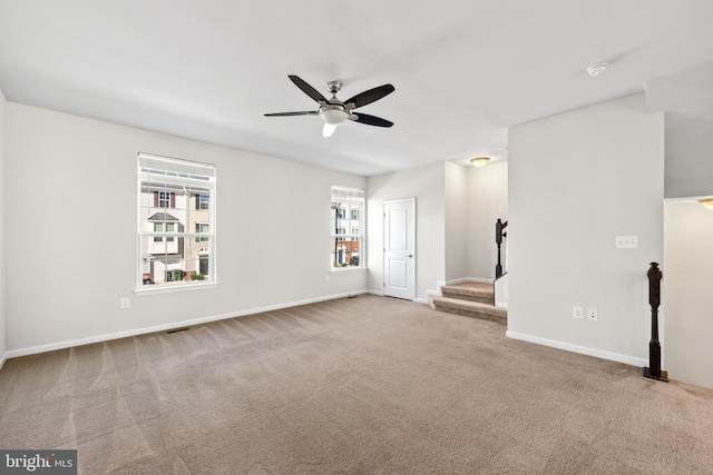 carpeted empty room featuring ceiling fan