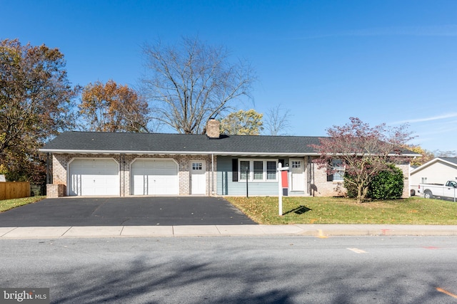 ranch-style house featuring a garage and a front lawn