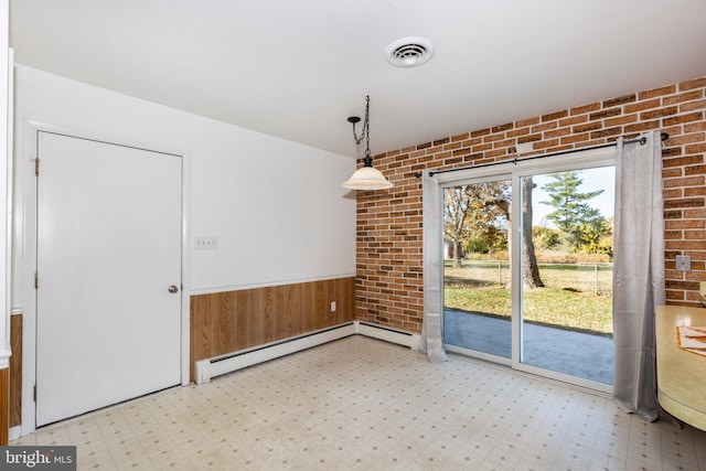 unfurnished dining area with a baseboard radiator and brick wall