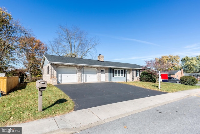 ranch-style house with a garage and a front yard