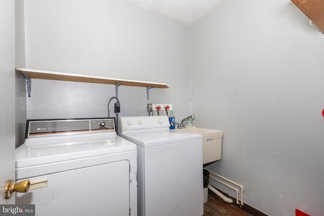 laundry area with dark hardwood / wood-style floors and independent washer and dryer