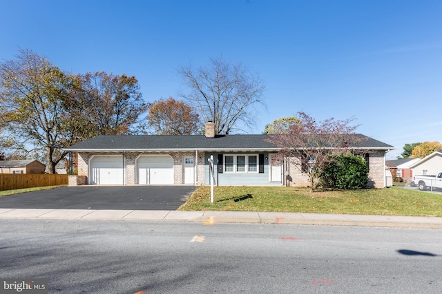 ranch-style house with a garage and a front yard