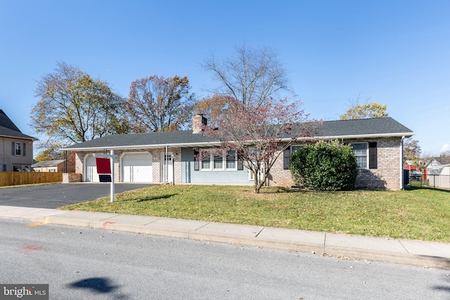 ranch-style house with a garage and a front lawn