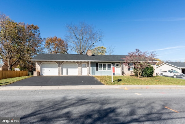 single story home with a garage and a front lawn