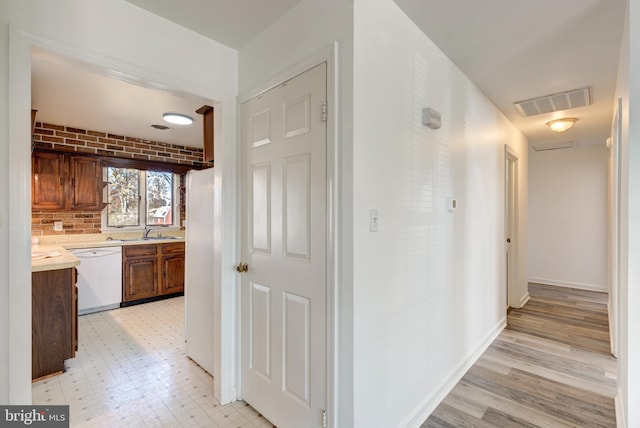 hallway with light hardwood / wood-style floors