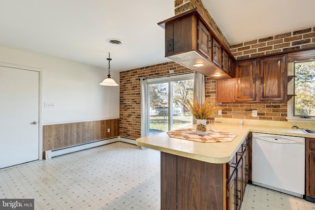 kitchen featuring dishwasher, brick wall, a wealth of natural light, and a baseboard heating unit