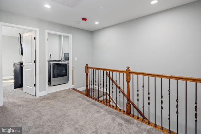 hall featuring light carpet and washer / dryer