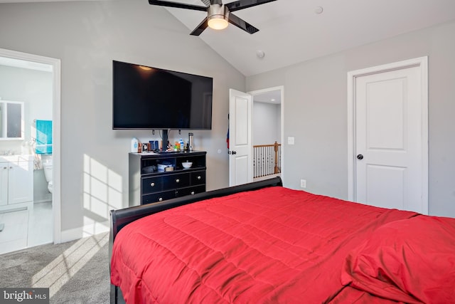 bedroom with carpet floors, vaulted ceiling, ceiling fan, and connected bathroom