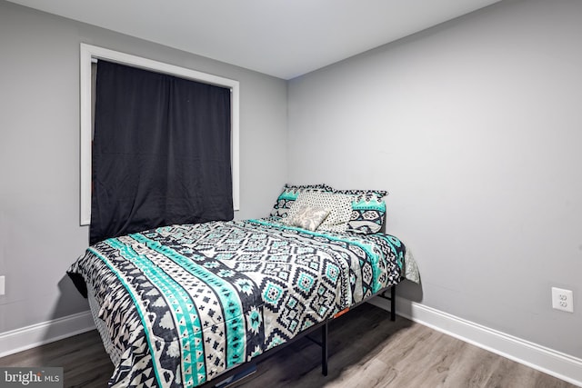 bedroom with hardwood / wood-style floors