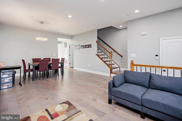 living room featuring a chandelier and light hardwood / wood-style flooring