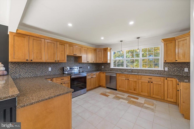 kitchen with decorative backsplash, sink, appliances with stainless steel finishes, and hanging light fixtures