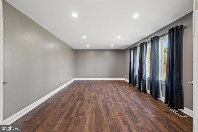 spare room featuring dark wood-type flooring