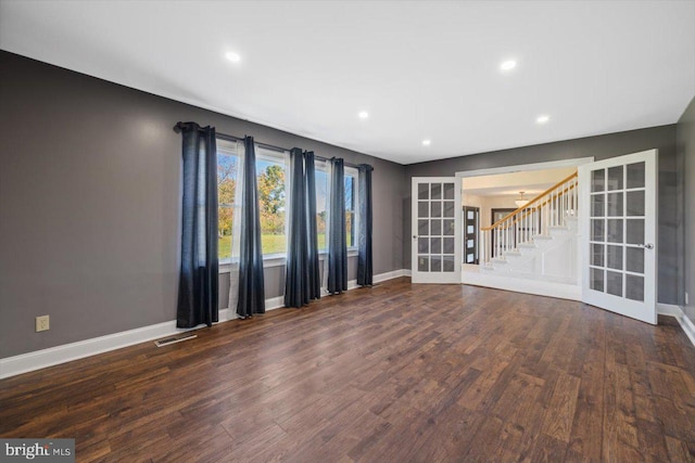 unfurnished room featuring french doors and dark wood-type flooring