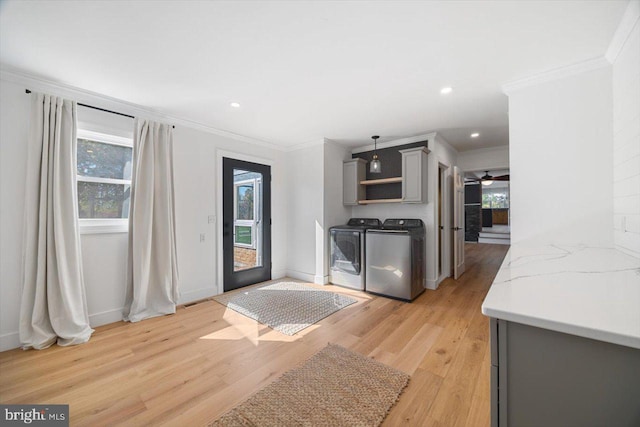 kitchen with gray cabinetry, light wood-type flooring, independent washer and dryer, ceiling fan, and ornamental molding