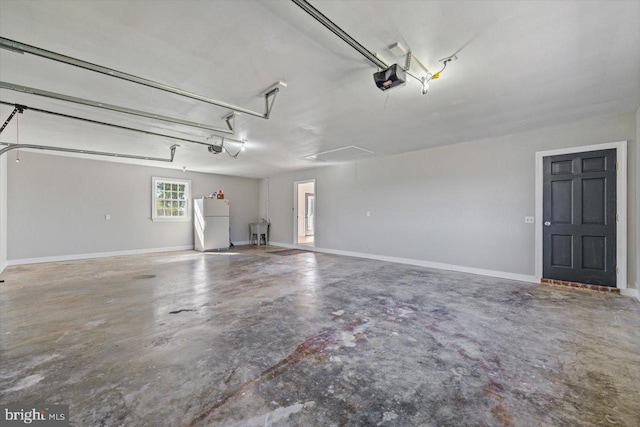 garage with a garage door opener and white refrigerator