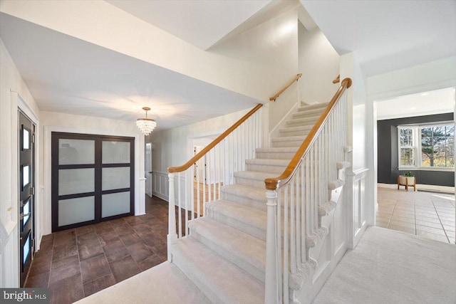 entrance foyer with a chandelier and dark hardwood / wood-style floors