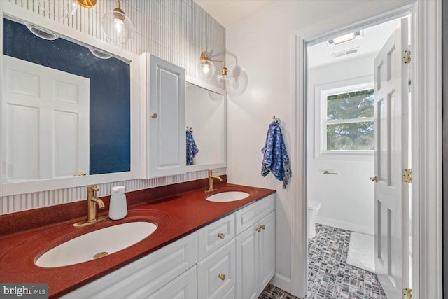 bathroom with vanity, toilet, and tile patterned flooring