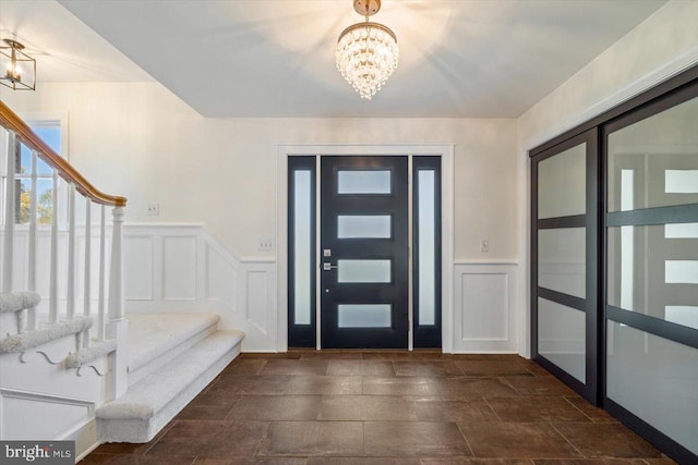 foyer entrance featuring an inviting chandelier