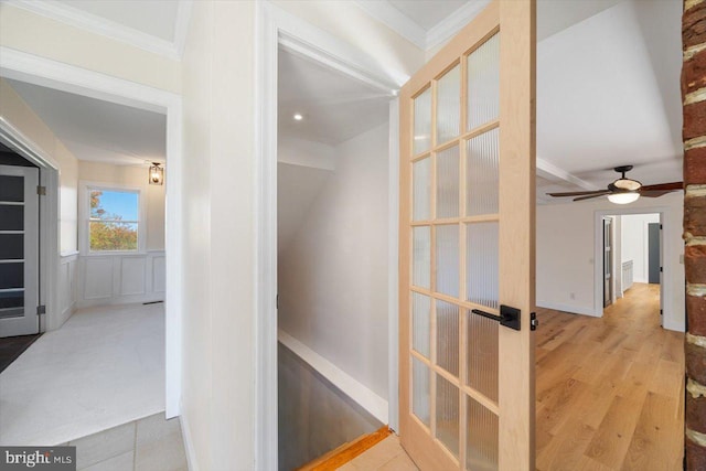 hall featuring light hardwood / wood-style flooring and crown molding