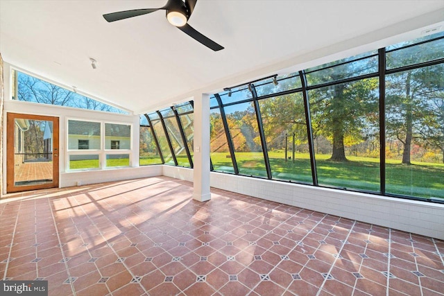 unfurnished sunroom featuring lofted ceiling, a healthy amount of sunlight, and ceiling fan