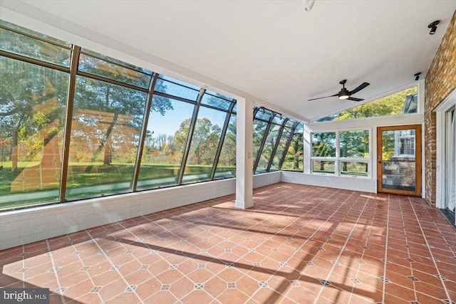 unfurnished sunroom featuring a water view, ceiling fan, a healthy amount of sunlight, and lofted ceiling