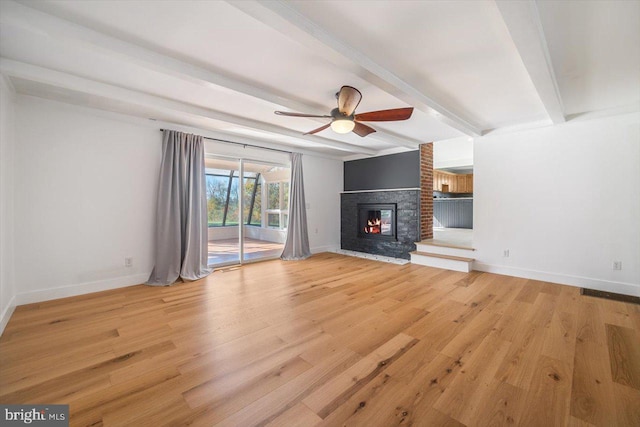 unfurnished living room with light hardwood / wood-style floors, beam ceiling, and ceiling fan