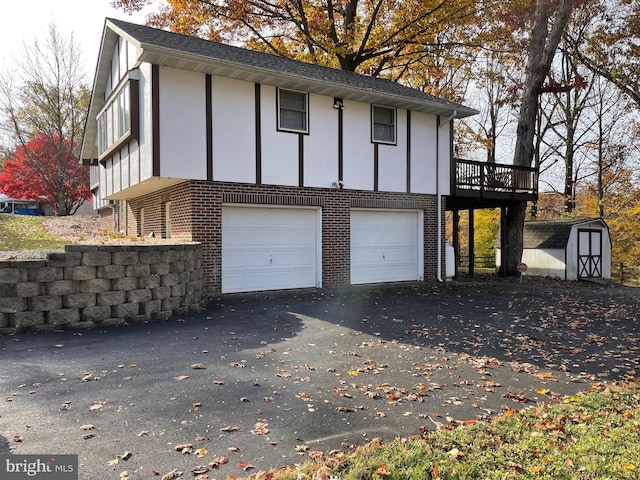 exterior space featuring a storage unit and a garage