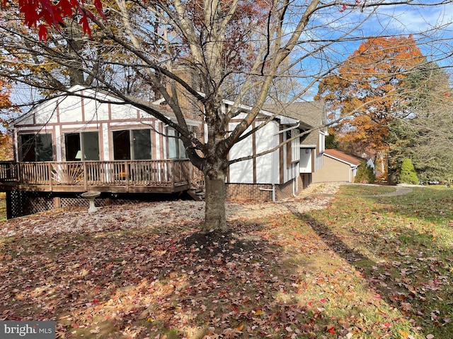 view of side of home featuring a wooden deck