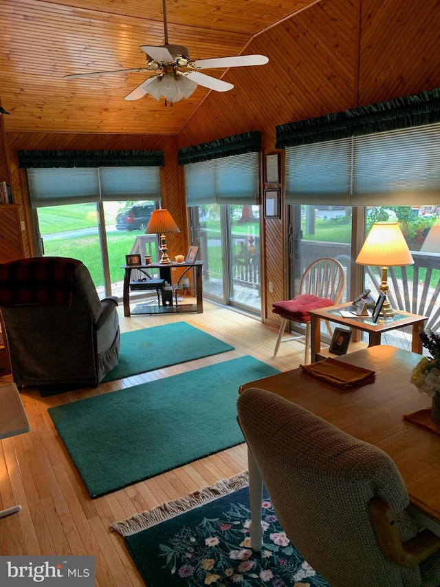 living room featuring light hardwood / wood-style floors, vaulted ceiling, wood ceiling, and ceiling fan