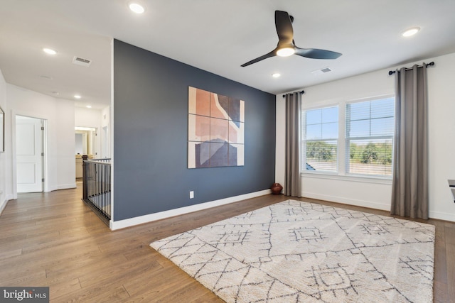 unfurnished room with ceiling fan and light wood-type flooring