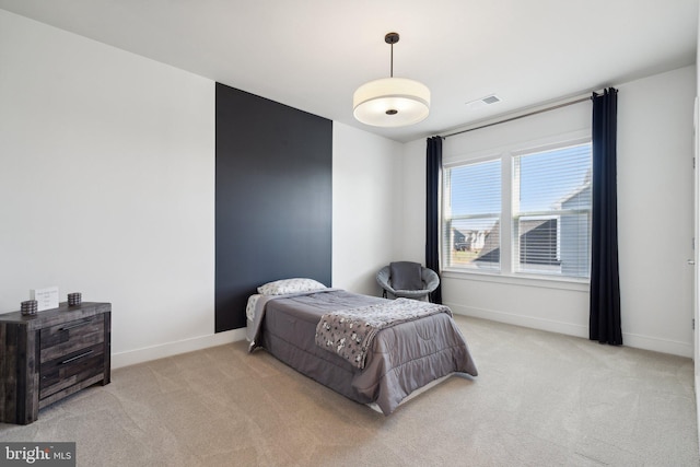 bedroom featuring light colored carpet