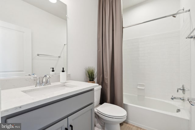 full bathroom featuring vanity, toilet, hardwood / wood-style flooring, and shower / bathtub combination with curtain