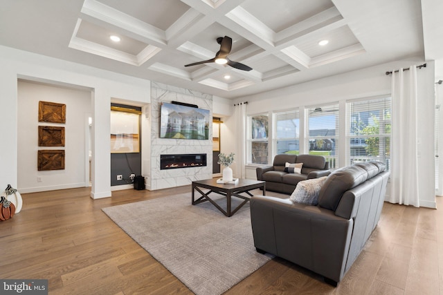 living room with coffered ceiling, wood-type flooring, and beamed ceiling