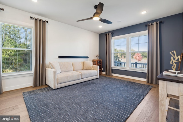 living room with wood-type flooring, a healthy amount of sunlight, and ceiling fan