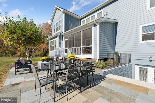 view of patio featuring a sunroom