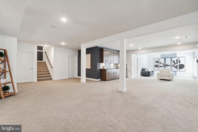 basement featuring light carpet