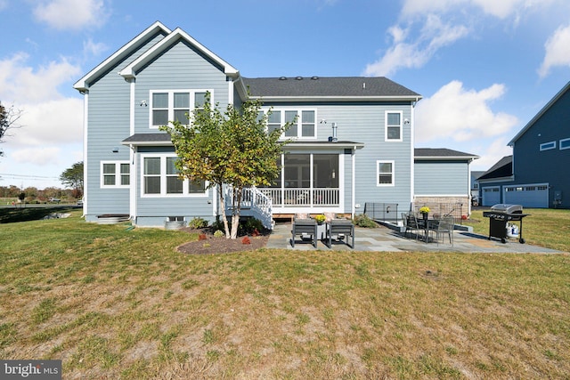 back of house featuring a yard, a patio area, and a sunroom