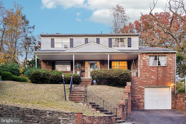 front facade with covered porch and a garage