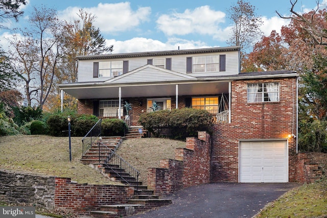 view of front property with covered porch and a garage